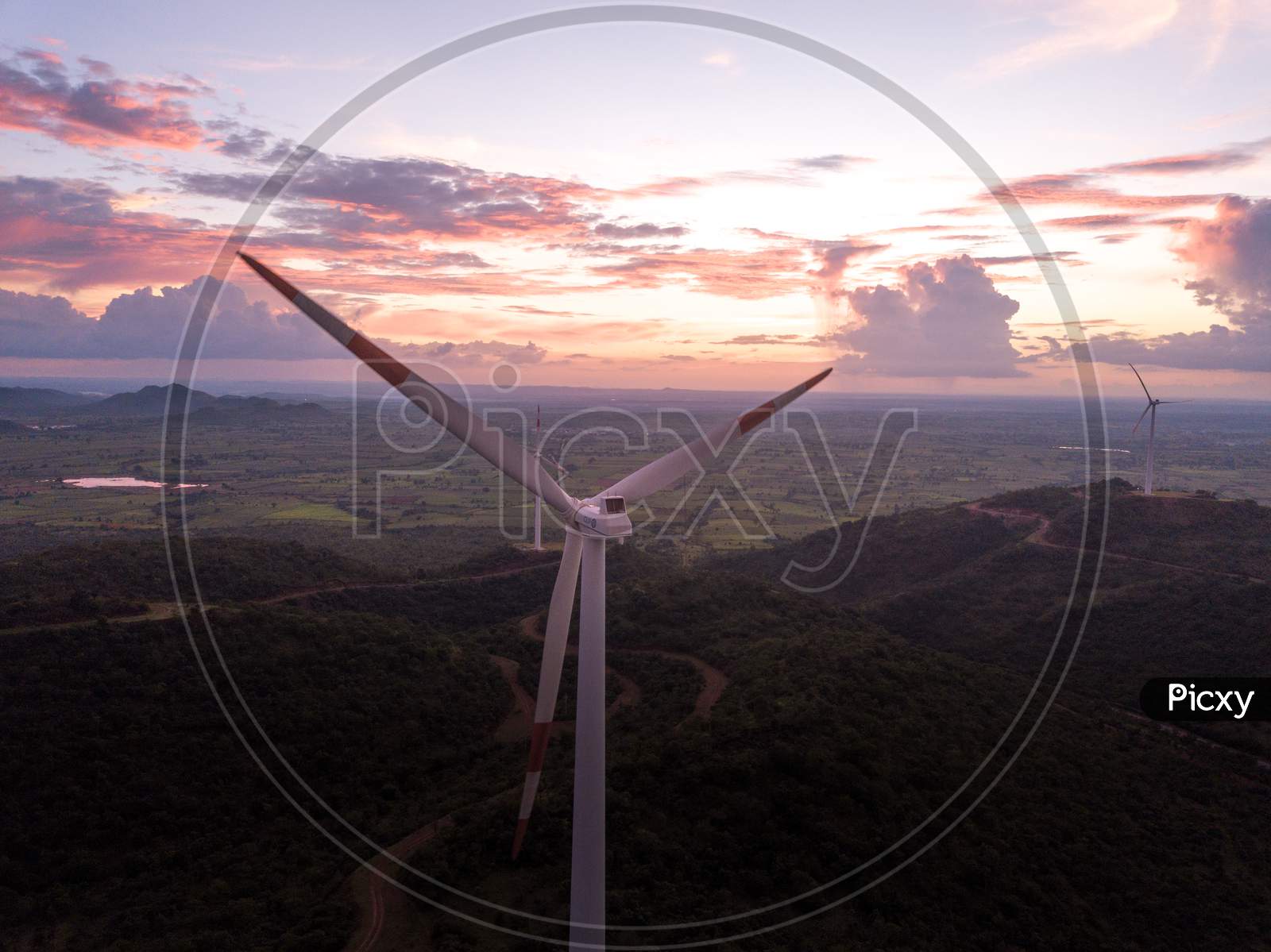 Aerial shot of windmills during sunset- close up