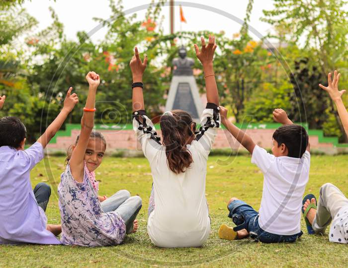 Group Of Young Children Cheering Up At Park - Teens Having Fun During Summer Vacation - Multi Ethnicity Children Playing Joyful By Braking The Racism.