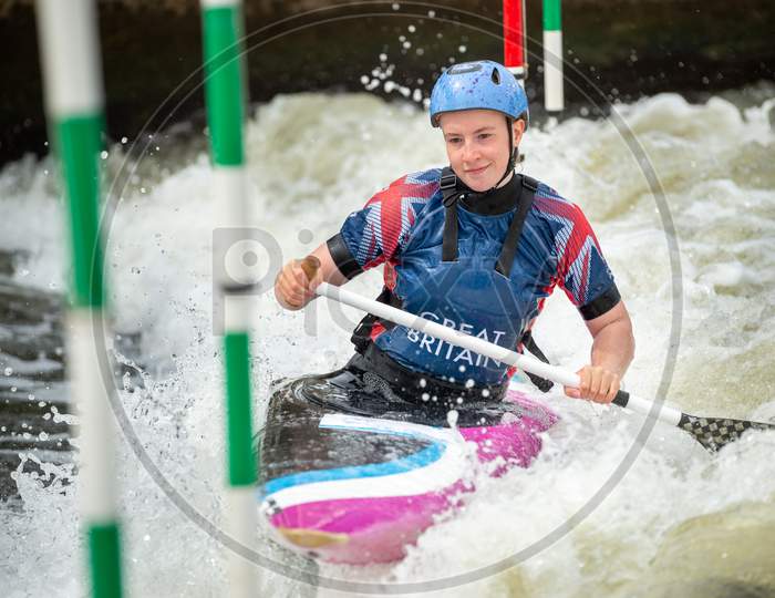 Close Up Of A Happy Gb Canoe Slalom Athlete Negotiating The Poles Of Slalom Gates On White Water In The C1W Class