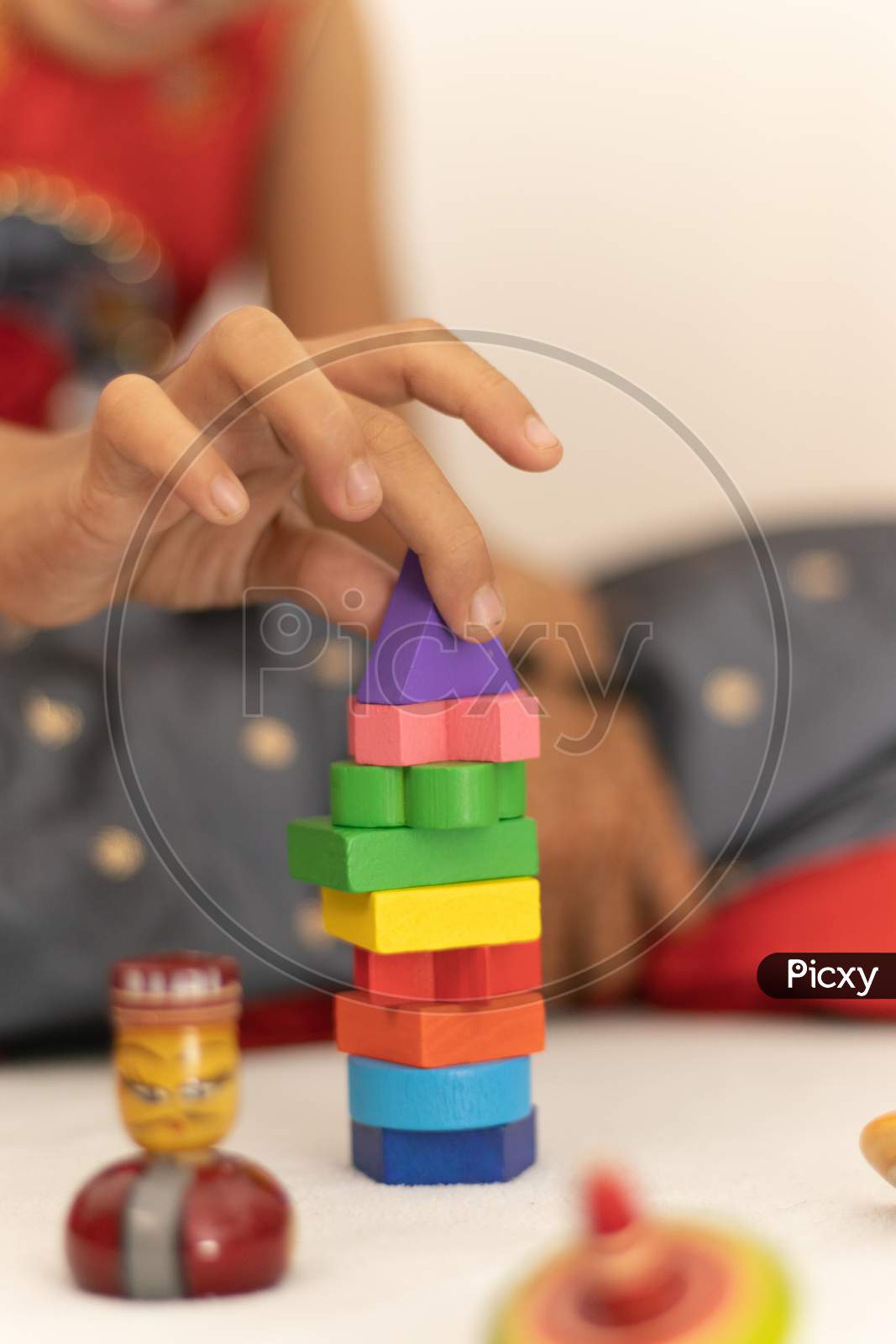 Focus On Hands Of Cute Little Child Girl Playing With Colorful Wooden Blocks In The Room