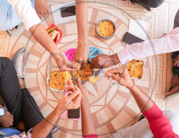 A Group of Young People Sharing their Lunch with Each other At a University Campus or College Campus