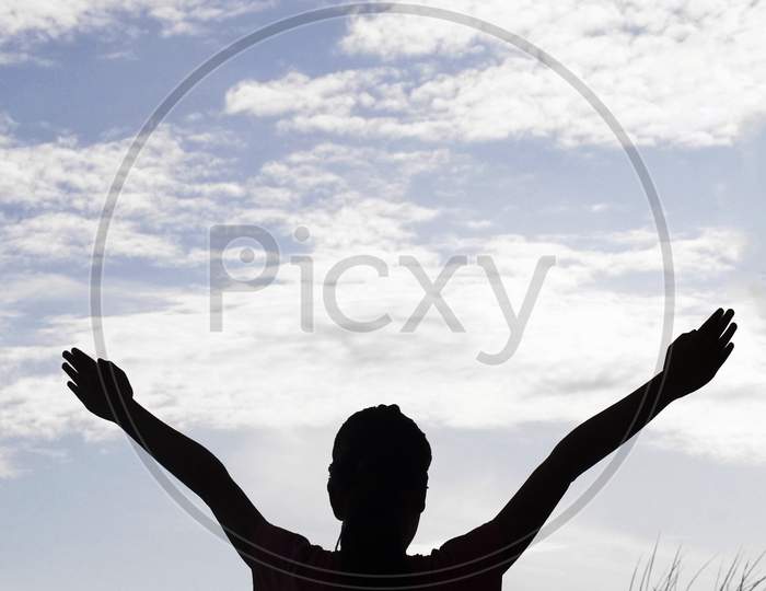 Silhouette of a Perso with hands raised