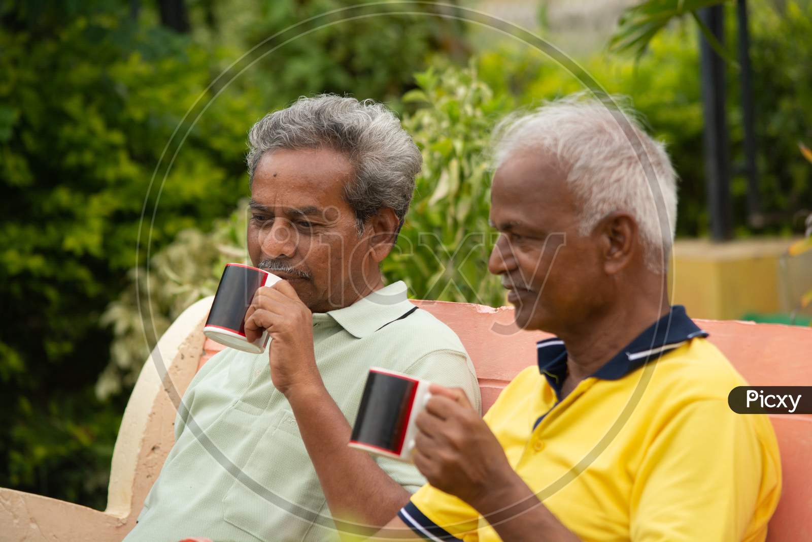 A Couple Of Elderly Man Or Old Men's having Tea or Coffee At Outdoors