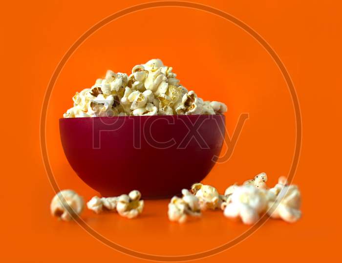 Pop Corns in a Bowl with orange Background