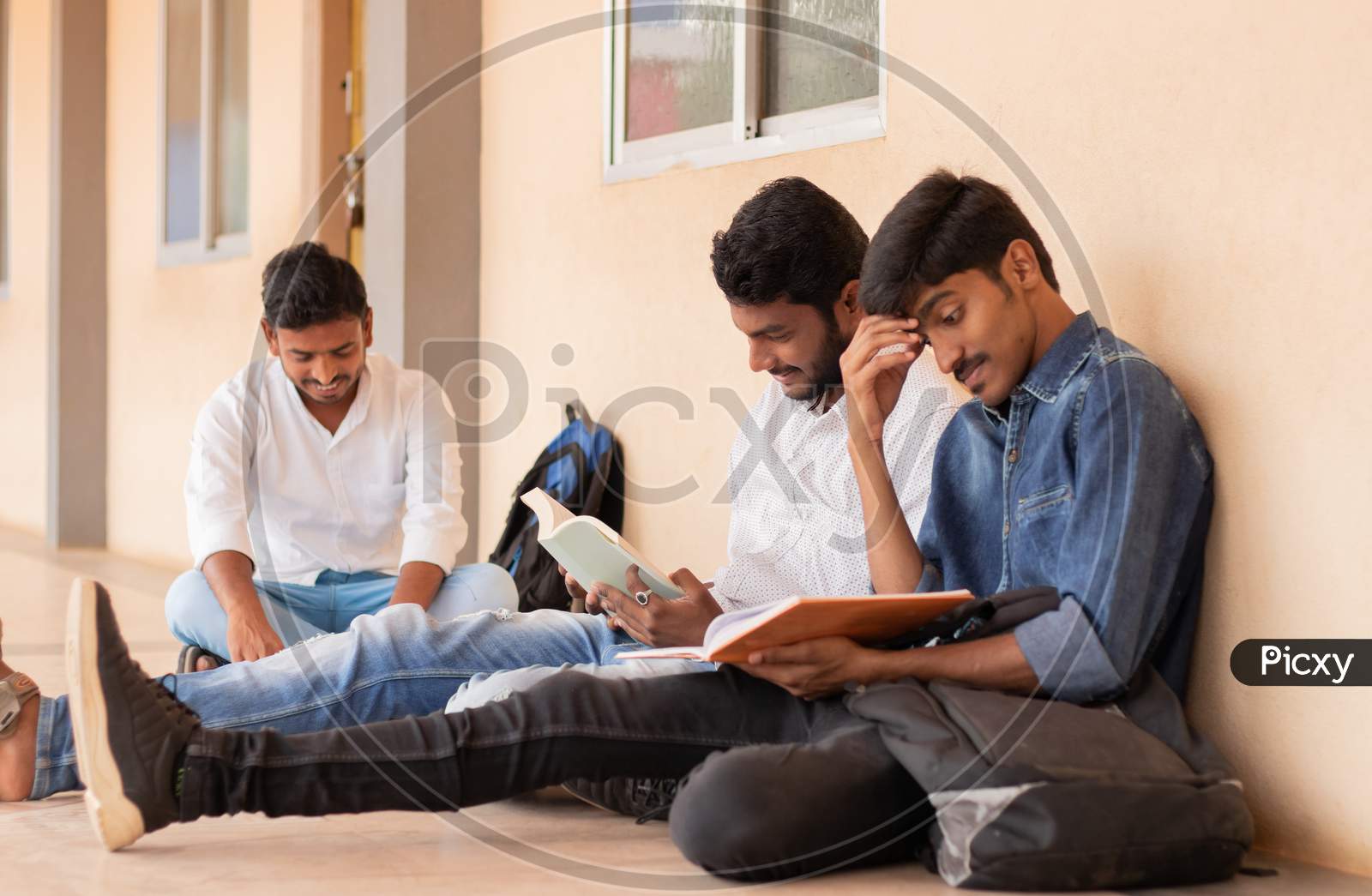 Group Of Students studying by Looking Into Books At College - Education, Learning Student, People Concept