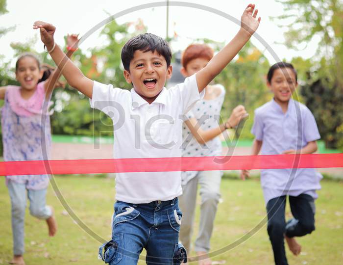 Happy Children Playing Running Race Outdoor Traditional Game - Concept Of Kids Enjoying Outdoor Games In Technology-Driven World.