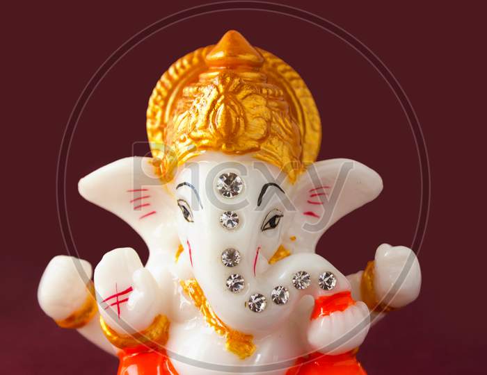 Lord Ganesha Idol with Maroon Background