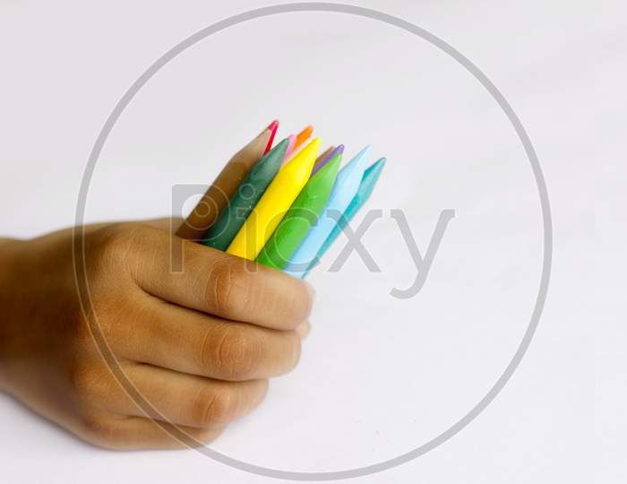 Close up shot of a Person holding Colour Pencil's