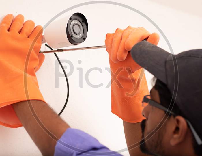 An Electrician mounting a CCTV Camera