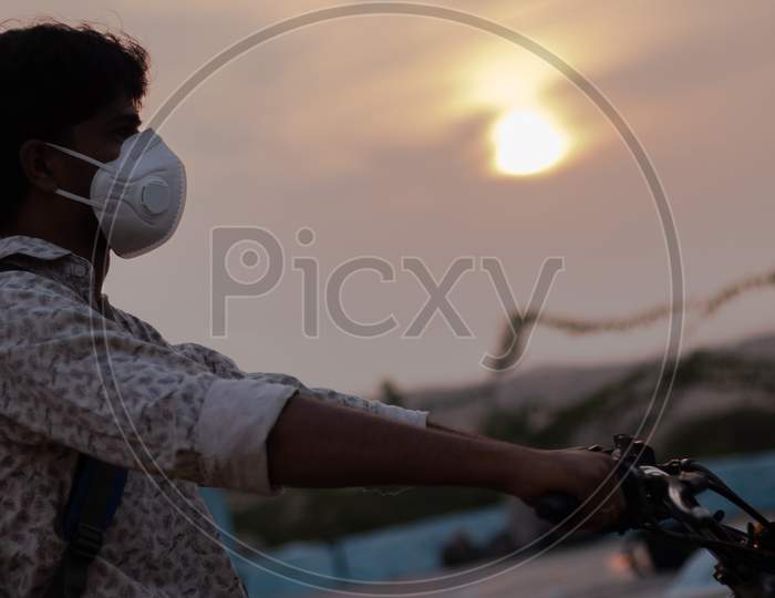 Close up shot of a Person Riding bike with Mask