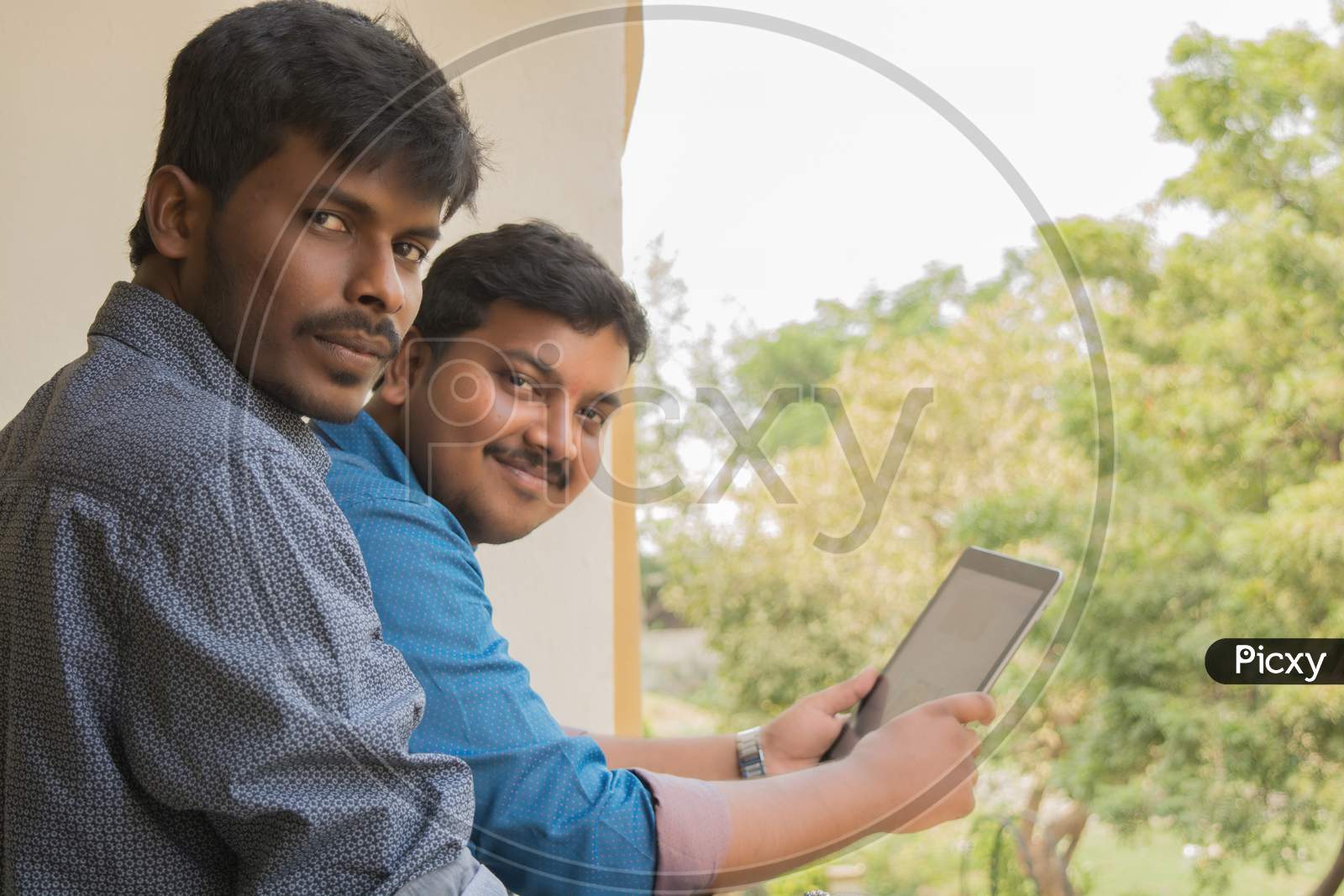 A couple of Happy Indian Men's with Laptop posing towards the Camer
