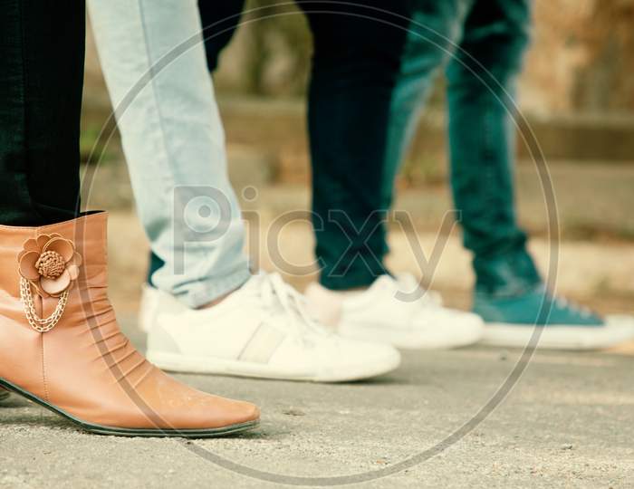 Close Up Of Legs, Group Of Friends Hanging Out Together - Friendship, Travel, Tourism, Summer Vacation And People Concept - Closeup Of Trendy Fashioned Millennials Walking In City.
