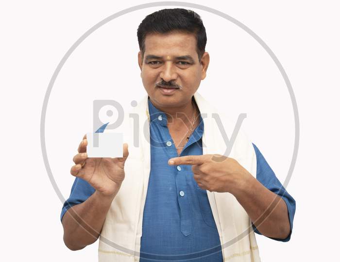 A Happy Indian Men in Traditional Dress pointing a Plain white card isolated with White Background