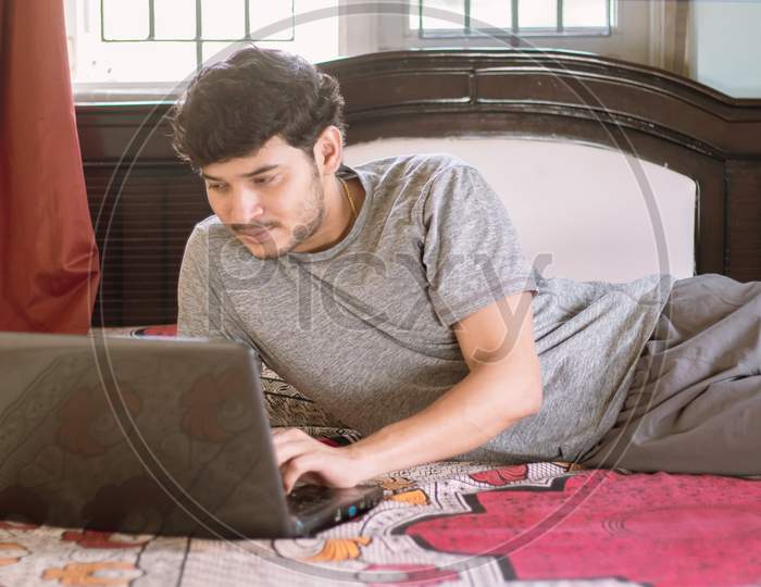 Young Indian Man using Laptop at Home - Concept of Work From Home