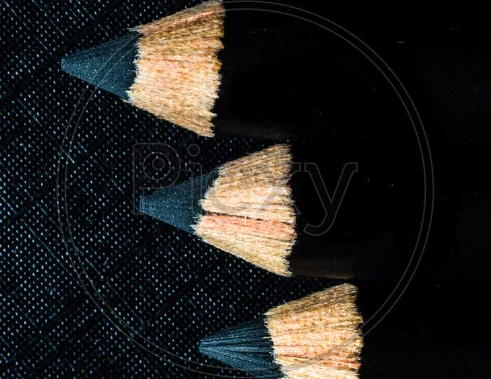 A Group Of Pencils Are Kept On A Dark Paper In Ascending Order