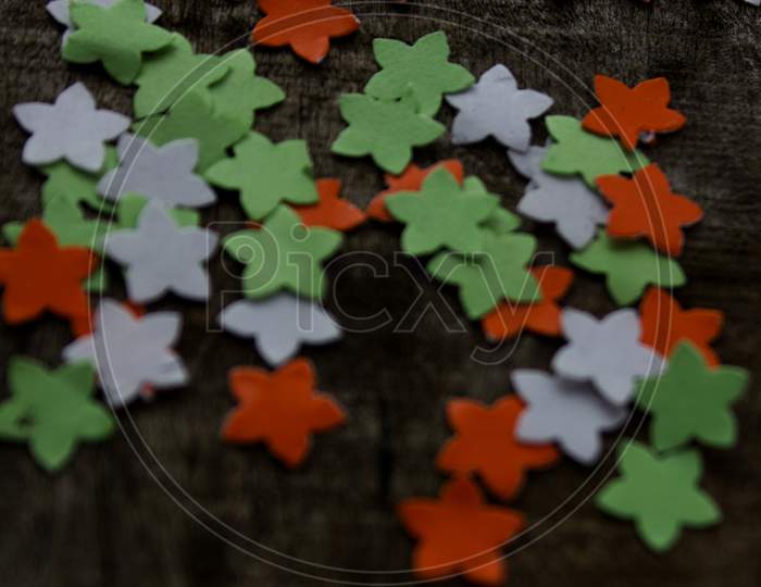 Colourful paper pieces on wooden background