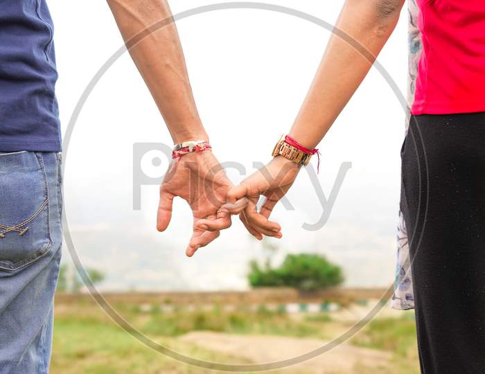 couple holding hands at nandi hills banglore