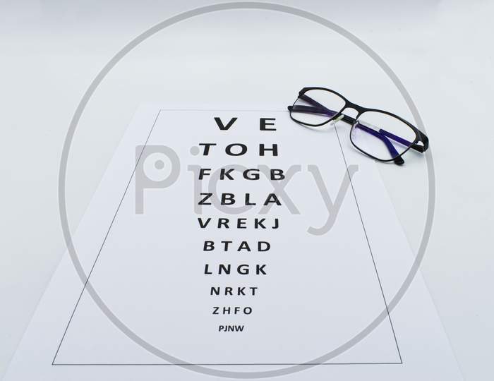 Checking vision table with glasses.