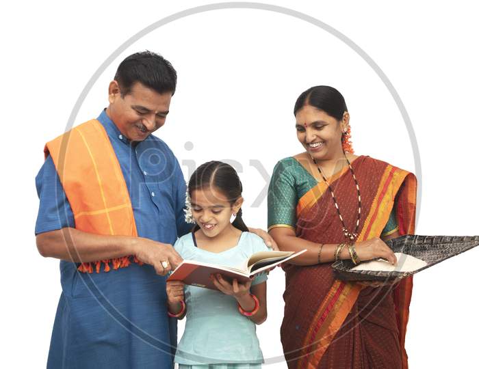 A Happy Three Membered Family Helping Child to Study