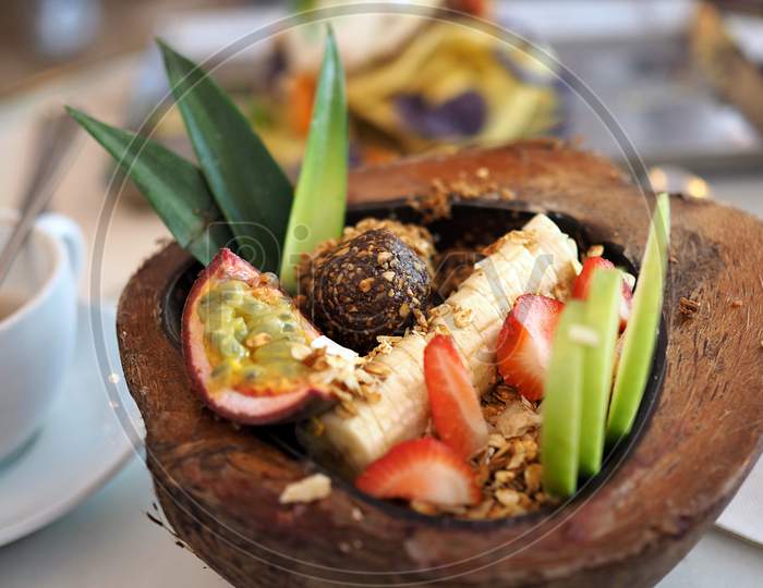 Fresh & Juicy fruit salad in a coconut shell.