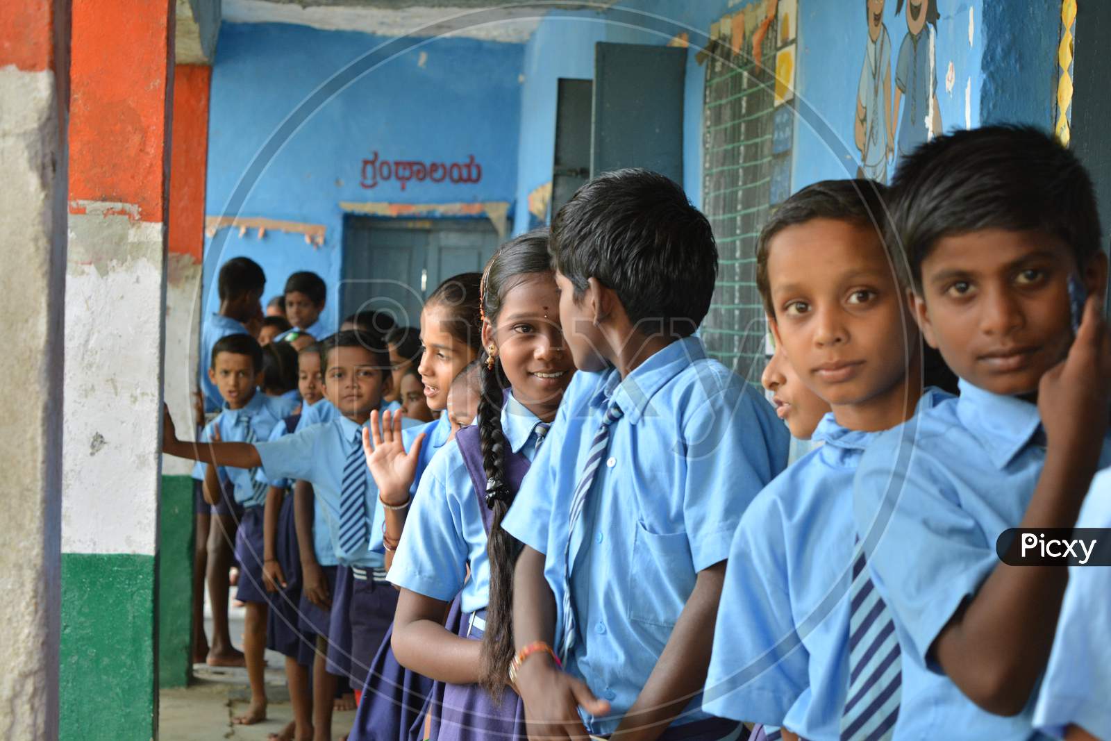 Mernal, Karnataka, India 25 July, 2019 : Government School Children Having Fun While Standing In Que
