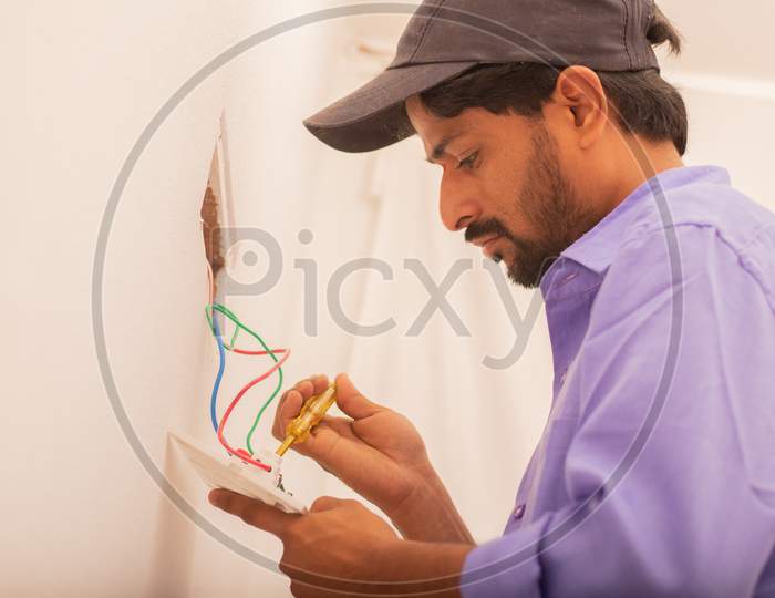 An Electrician setting up a Switch Board