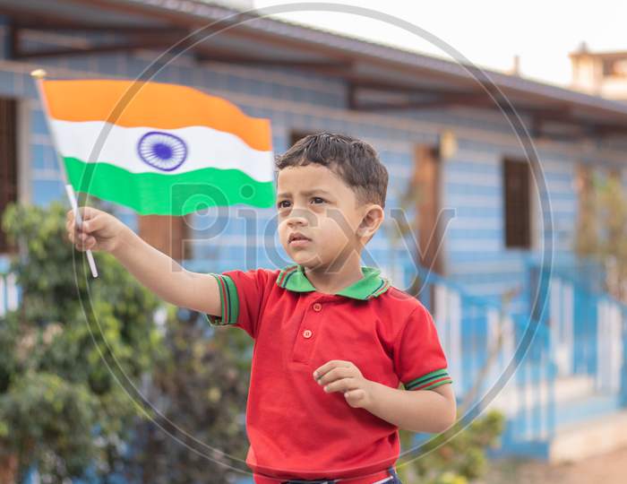 A Kindergarten Kid Waving India Flag