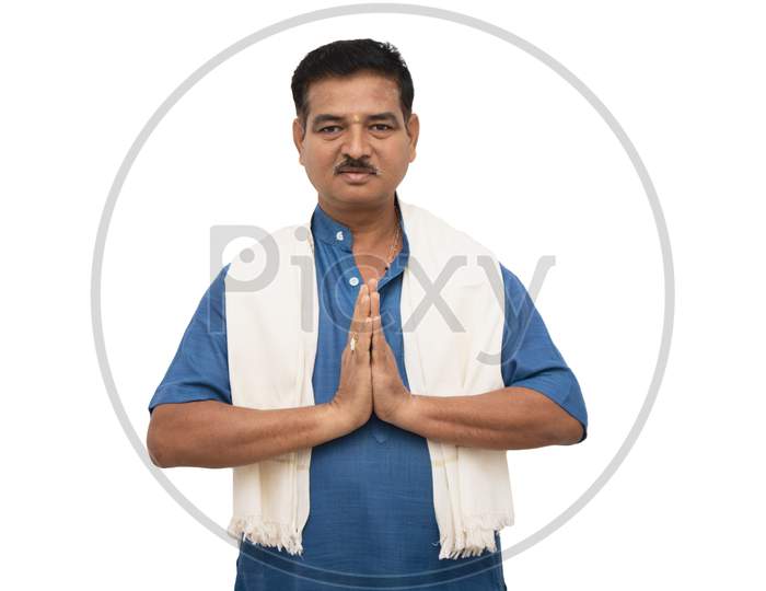 Handsome Indian Man In Traditional Ware Showing Namaste Gesture On Isolated Background.