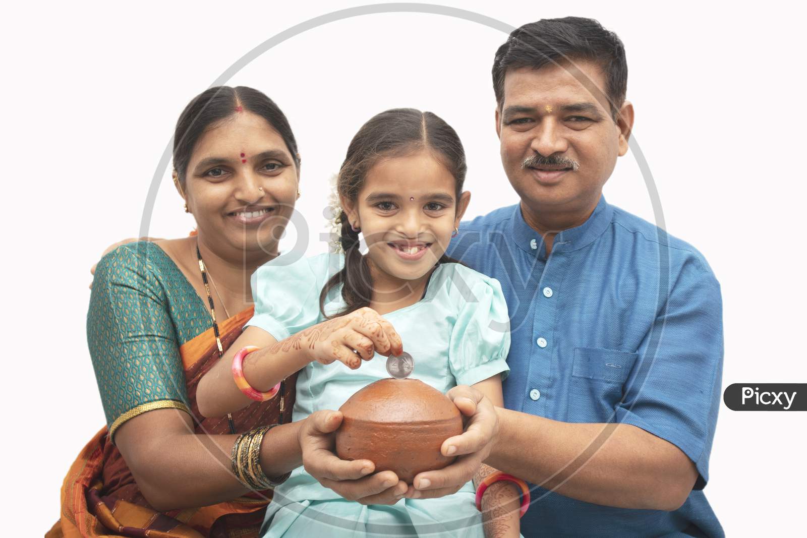 A Happy Three membered Indian family with a kid holding money saving pot isolated with White Background