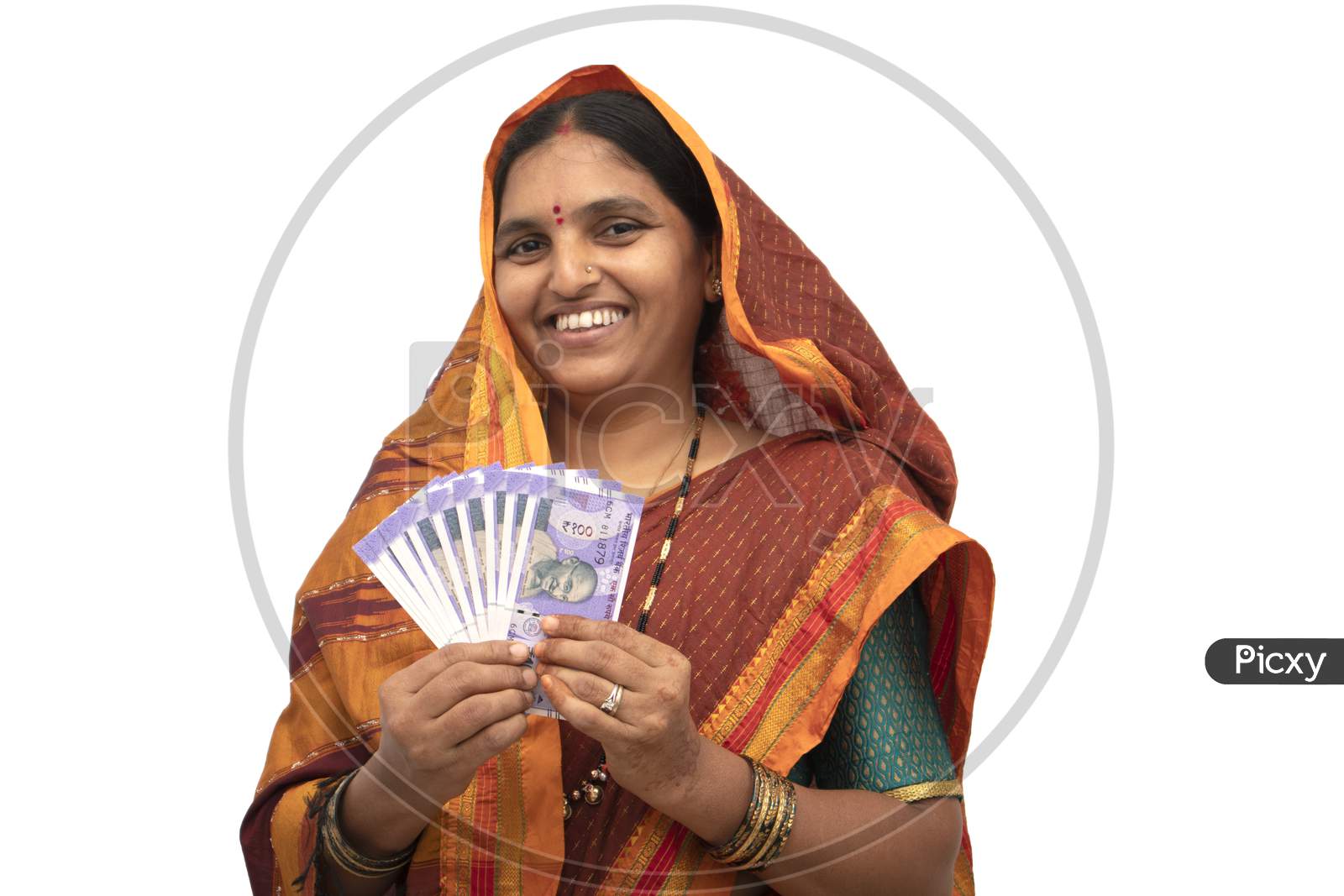 A Happy Indian woman in Traditional Saree showing Indian Currency Notes isolated with White Background
