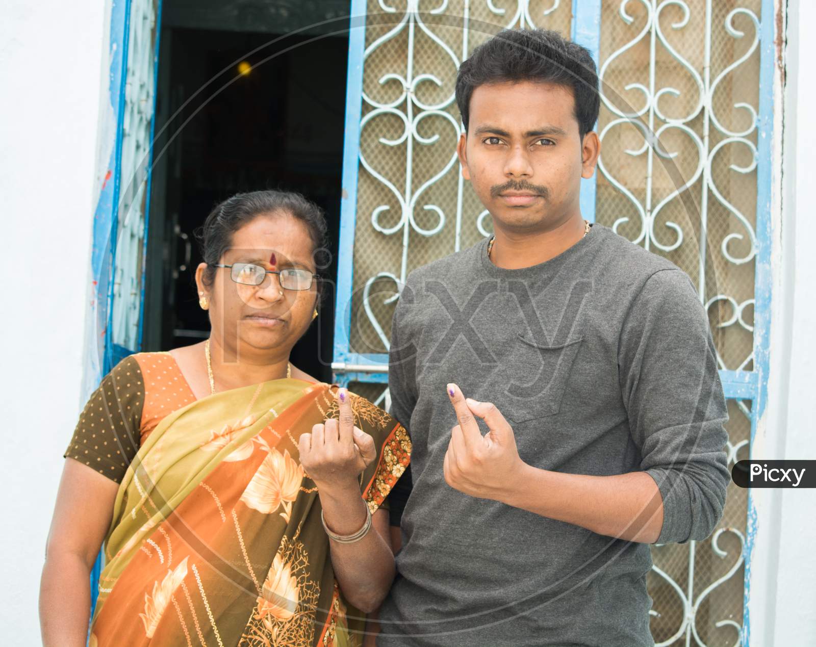 Indian Women and Young men Showing their Voted Fingers