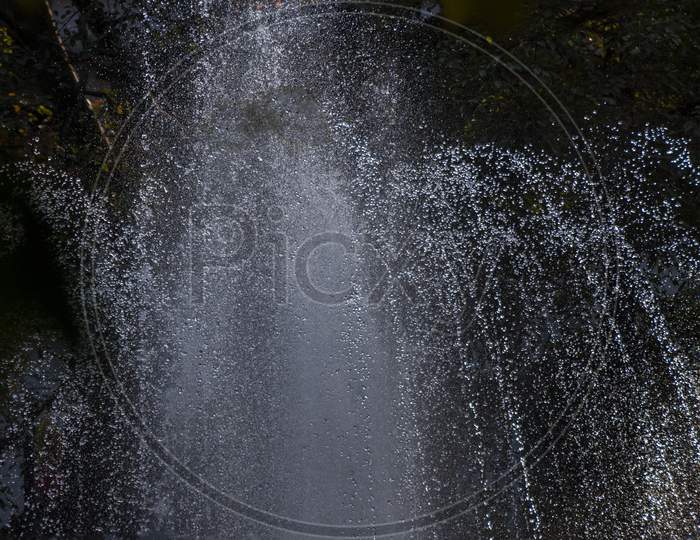 A Water Fountain In Action In The Evening