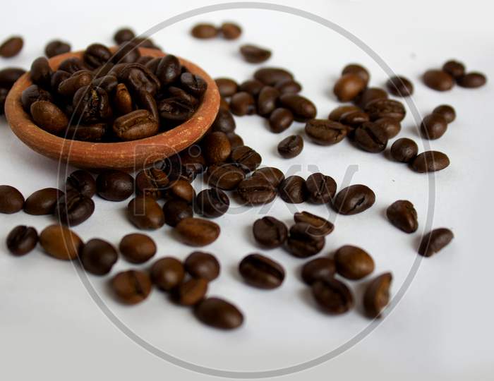 Coffee Beans in a Clay bowl with White Background