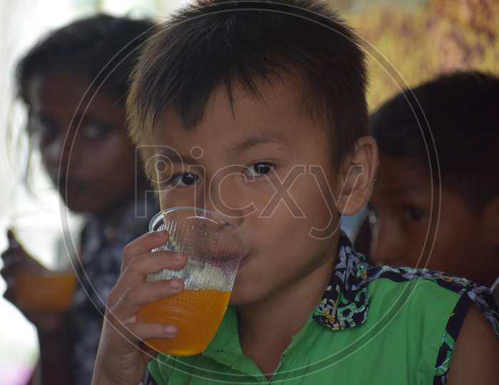 Small boy drinking cold drinks