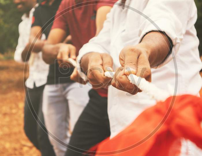 Close Up Of Hands Playing Tug Of War - Group Of Friends Playing Outdoor Games In Changing Digital And Technology World.