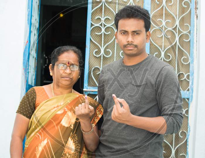 Indian Women and Young men Showing their Voted Fingers