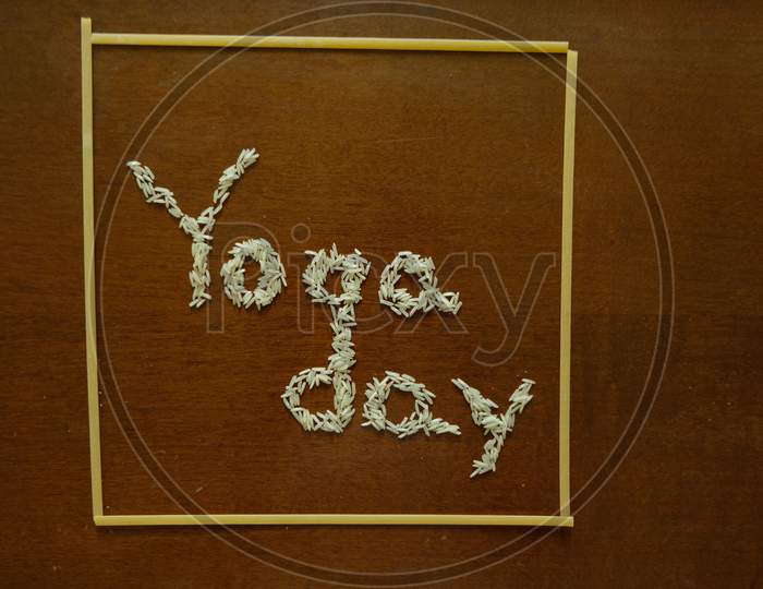 Yoga day text with spaghetti on a dark background