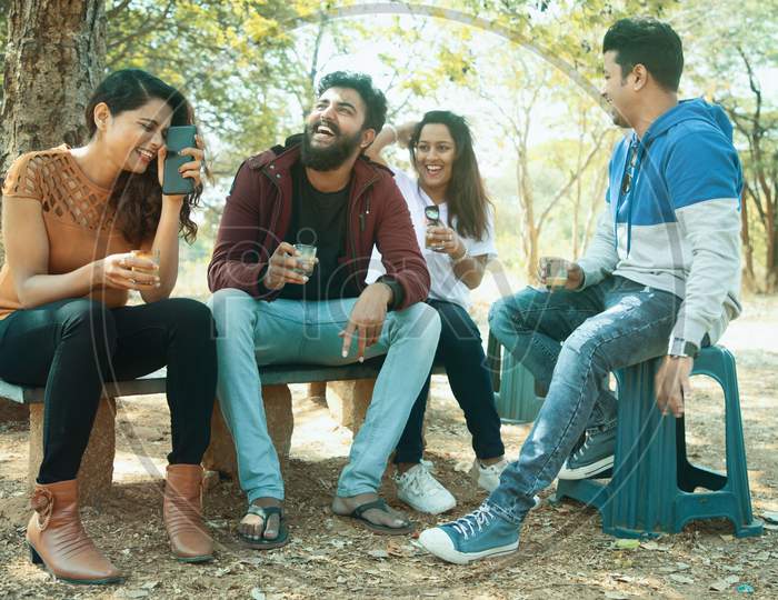 A Group of Happy Young People talking to each other with a Happy face At Outdoors