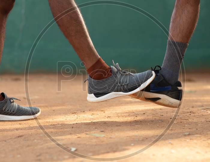 Close up shot of two Young Men's with Sports Shoe in a Tennis Court