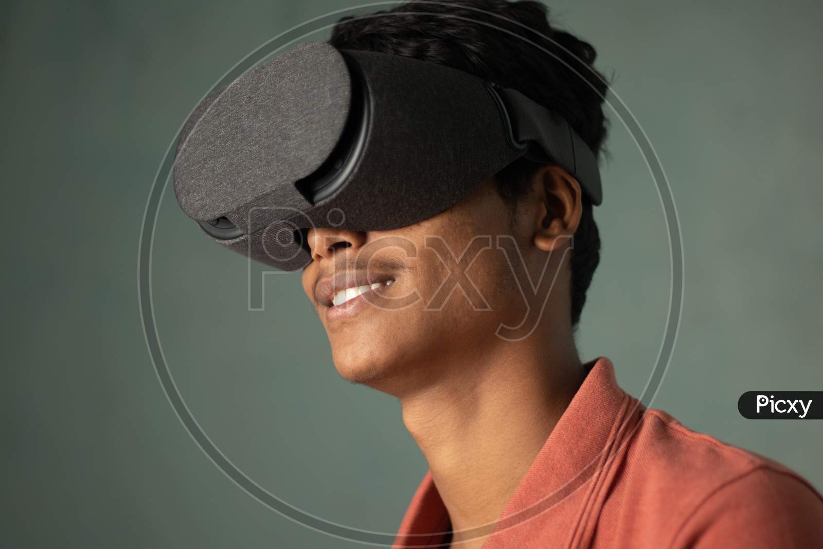 Portrait Of A Young Man Experiencing Virtual Reality Through A Vr Headset.