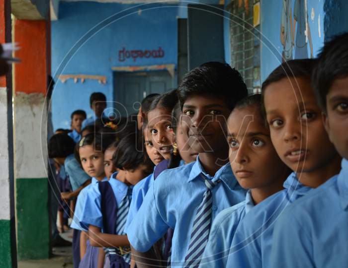 Mernal, Karnataka, India 25 July, 2019 : Government School Children Having Fun While Standing In Que.