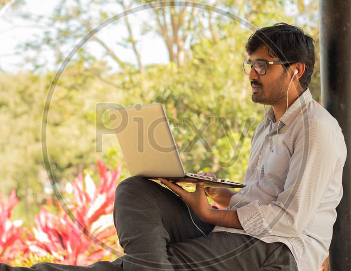 A Student Using Laptop at University Campus