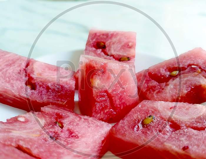Fresh Red Watermelon Pieces On A White Plate In White Background.