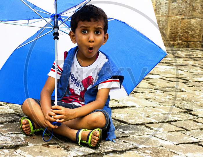 Portrait of a Young Indian Boy with an umbrella