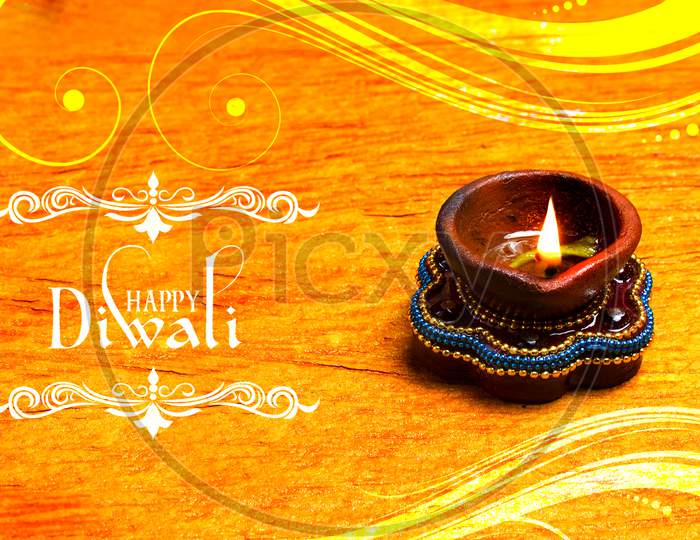 Selective Focus on Lighted Diya / A Concept of Happy Diwali Greetings