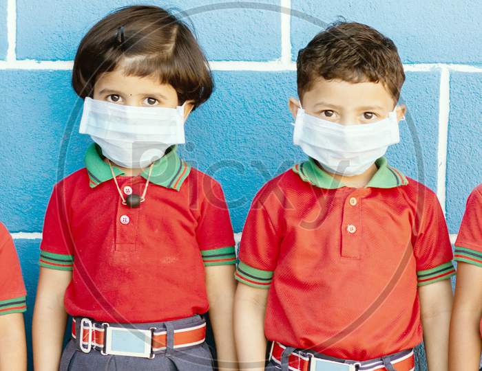 School Preteen Kids With Protection Face Mask Against New Coronavirus, Covid -19, Ncov 2019 Or Sars Cov 2 Virus At School - Children Wore Medical Mask Due To Coronavirus Outbreak.