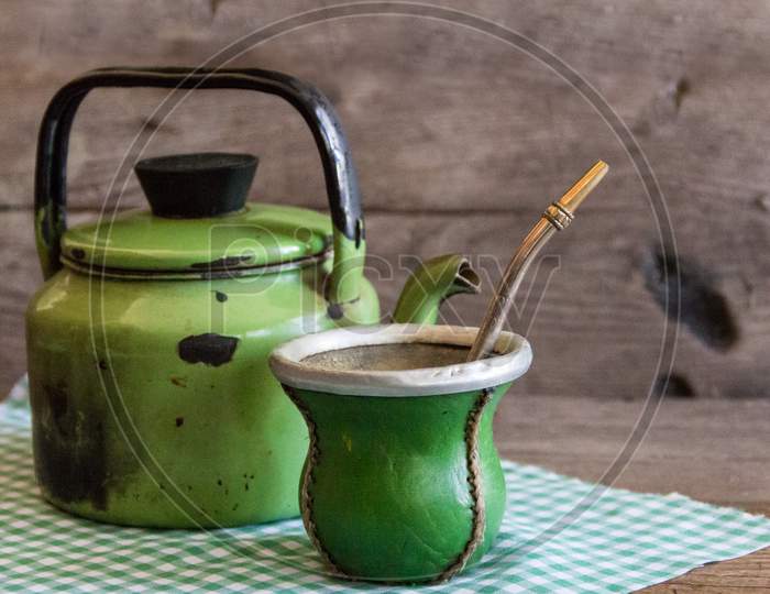 Mate And Kettle, Traditional Argentine Yerba Mate Infusion, On Rustic Wooden Background