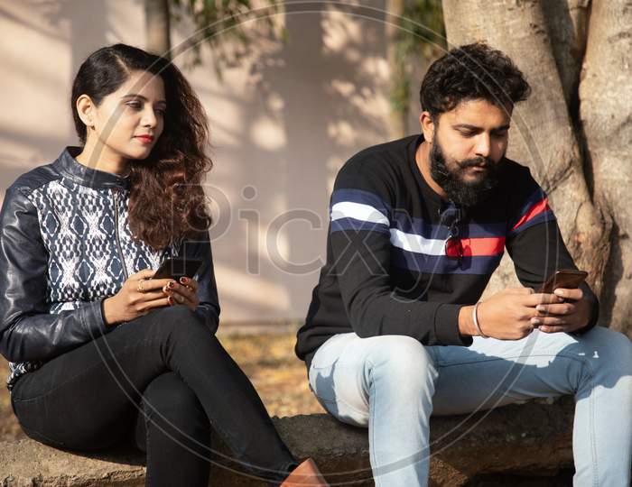 A Happy Young Couple using Smartphone