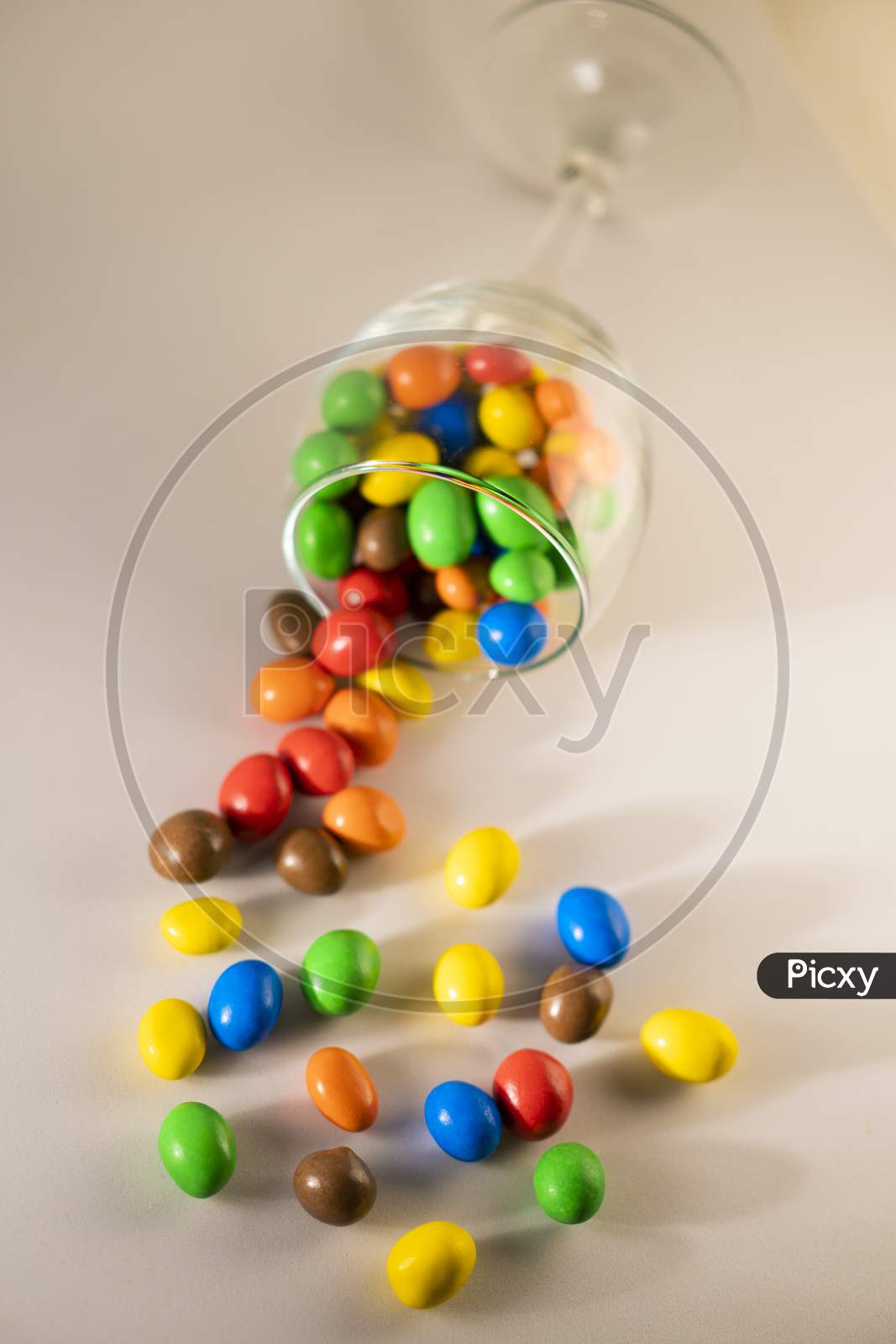 Multicolor chocolate candy or candy balls scattered on a white background.