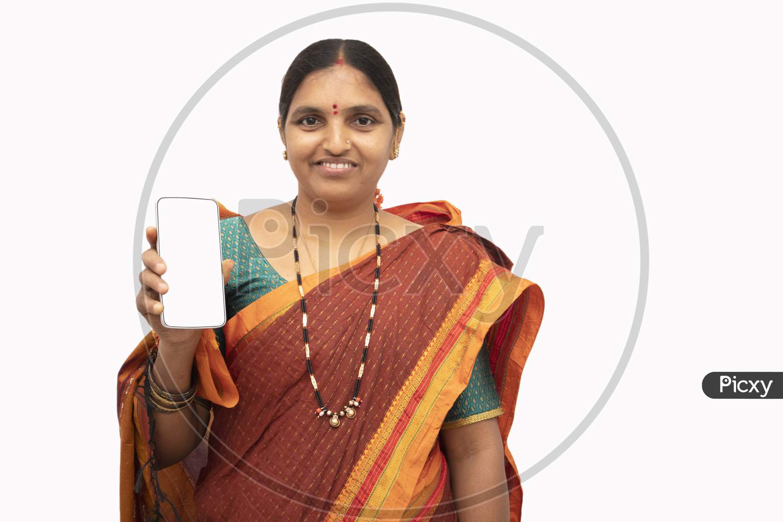 A Happy Indian woman in Traditional Saree showing Smartphone or Mobile Phone isolated with White Background